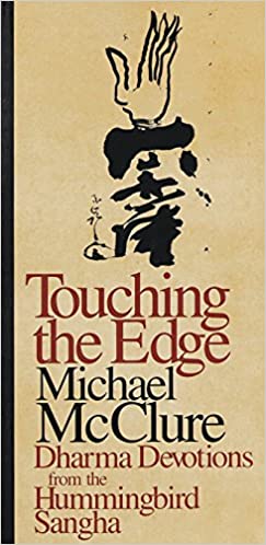 A tan book cover with a black spine, with alternating color text on the cover: Touching the Edge (burgundy, very large), Michael McClure (Black, Very large), Dharma Devotions from the Hummingbird Sangha (Burgundy, smaller). Text is under an image that appears to be a hand arising out of some kind of script or inky shape.